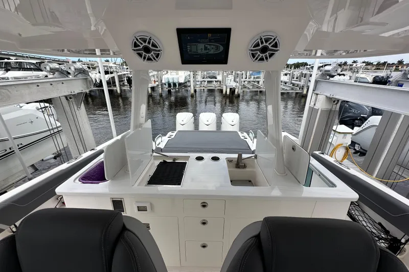 Slide: The Image of 2025 Regal 38 SAV boat interior with modern amenities and sleek design at a marina. - 9