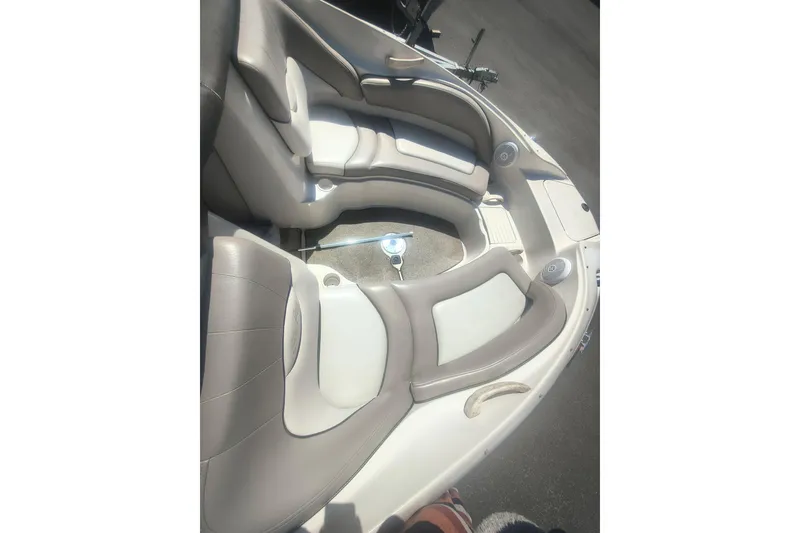 Slide: The Image of 2004 Sun Deck 220 boat interior with cushioned seating and cup holders. - 4