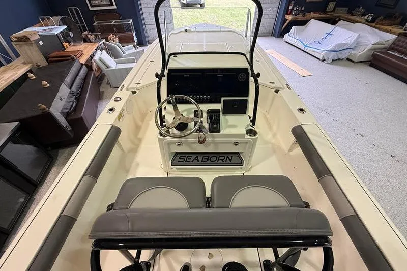 Slide: The Image of 2023 Sea Born FX22 Bay boat interior with steering console and seating. - 10
