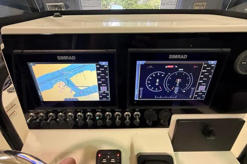 Slide: The Image of Simrad navigation displays on 2023 Sea Born FX22 Bay boat dashboard. - 13