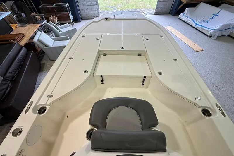Slide: The Image of 2023 Sea Born FX22 Bay boat interior, featuring spacious deck and seating in a garage setting. - 15