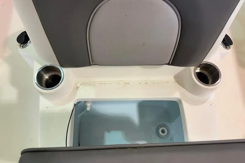 Slide: The Image of 2023 Sea Born FX22 Bay boat interior with cup holders and storage compartment. - 17