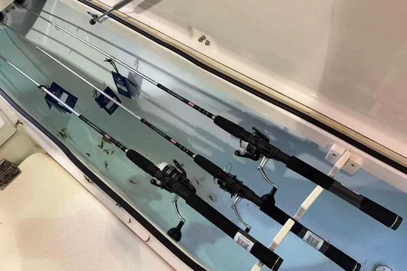 Slide: The Image of Fishing rods stored in a 2023 Sea Born FX22 Bay boat compartment. - 18