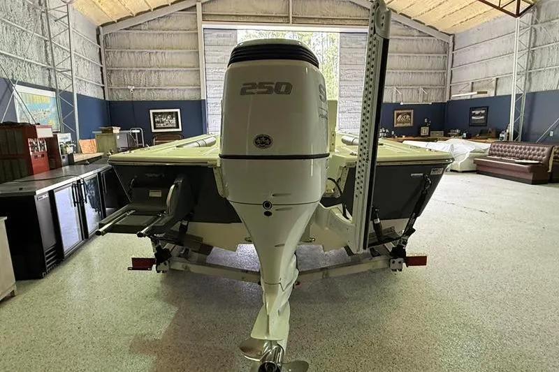 Slide: The Image of 2023 Sea Born FX22 Bay boat with 250 horsepower engine in a spacious garage. - 2
