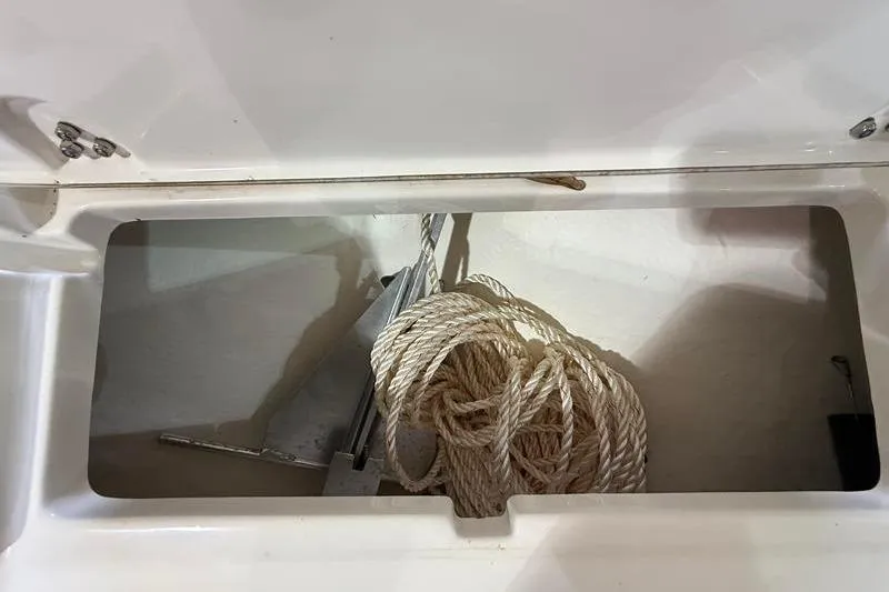 Slide: The Image of Storage compartment of 2023 Sea Born FX22 Bay boat with rope and anchor. - 22