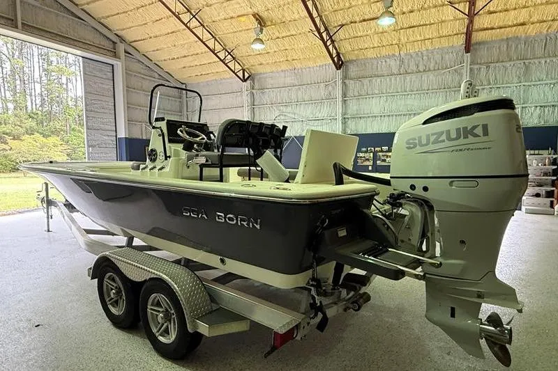 Slide: The Image of 2023 Sea Born FX22 Bay boat with Suzuki outboard motor in a storage facility. - 3