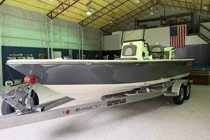 Slide: The Image of 2023 Sea Born FX22 Bay boat on trailer in a spacious indoor setting. - 4