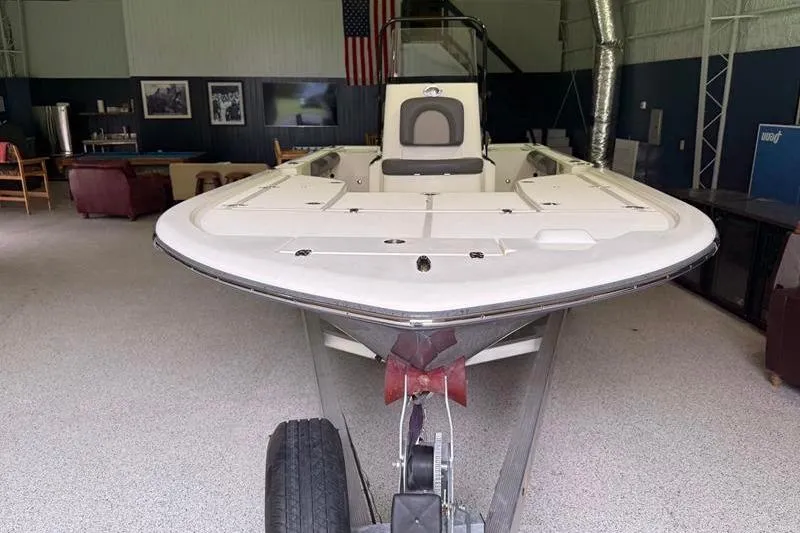 Slide: The Image of 2023 Sea Born FX22 Bay boat on trailer in indoor setting. - 5