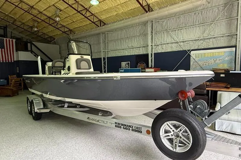 Slide: The Image of 2023 Sea Born FX22 Bay boat on trailer in indoor showroom. - 6