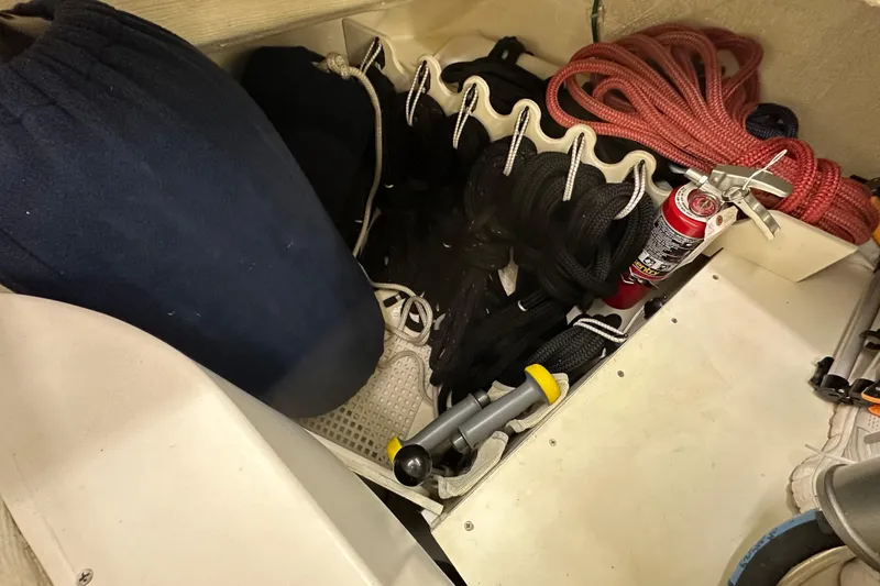 Slide: The Image of Storage compartment on a 2007 Sabre 386 sailboat with ropes and a fire extinguisher. - 103