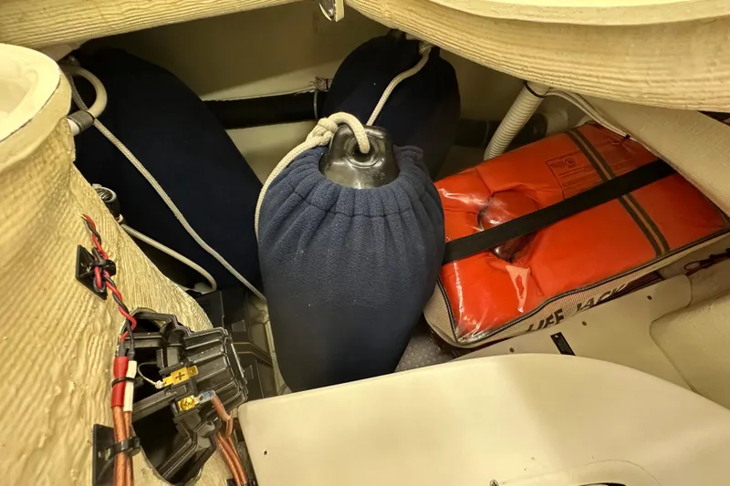 Slide: The Image of Storage compartment in a 2007 Sabre 386 sailboat with life jacket and fenders. - 106