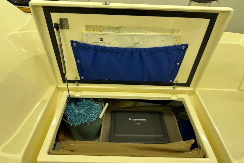 Slide: The Image of Storage compartment in a 2007 Sabre 386 sailboat with navigation equipment and maps. - 116