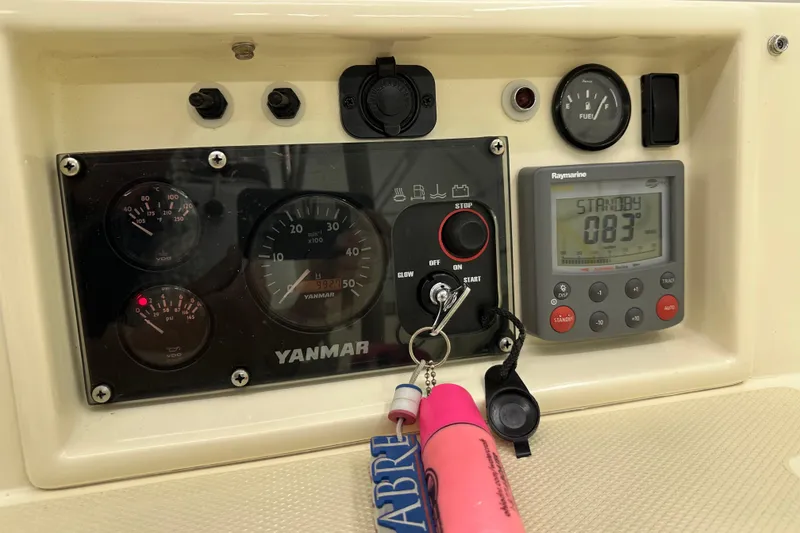 Slide: The Image of Control panel of a 2007 Sabre 386 boat with Yanmar gauges and Raymarine display. - 117