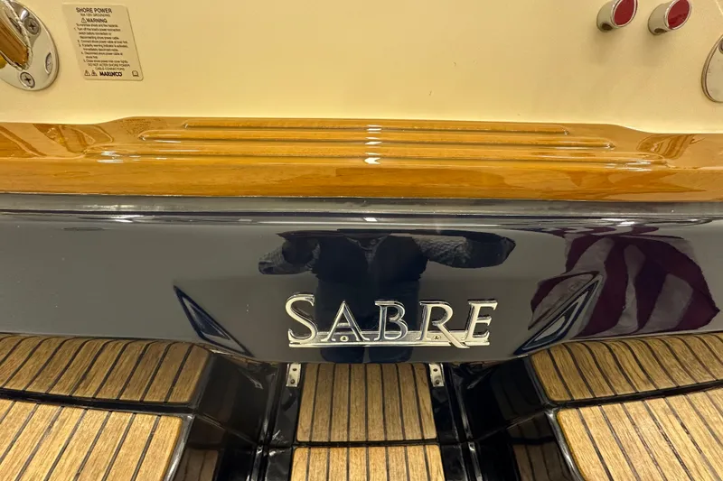 Slide: The Image of 2007 Sabre 386 boat stern with wood accents and brand logo. - 119