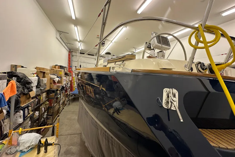 Slide: The Image of 2007 Sabre 386 sailboat in storage, surrounded by shelves and equipment. - 121