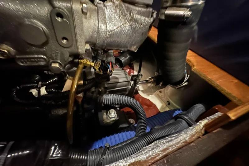 Slide: The Image of Engine compartment of a 2007 Sabre 386 sailboat, showcasing mechanical components and wiring. - 132