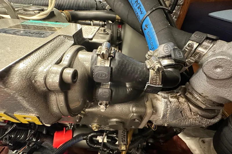 Slide: The Image of Engine components of a 2007 Sabre 386, featuring hoses and clamps in a marine setting. - 134