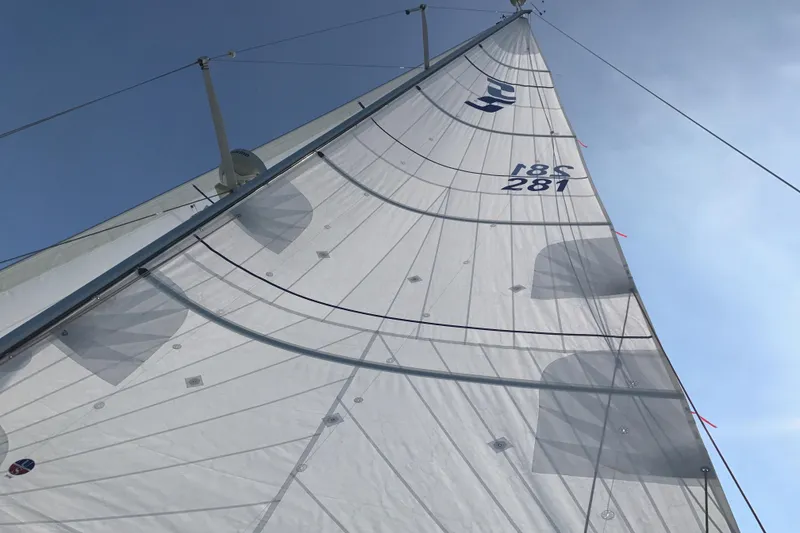 Slide: The Image of Sail of a 2007 Sabre 386 yacht against a clear blue sky. - 145