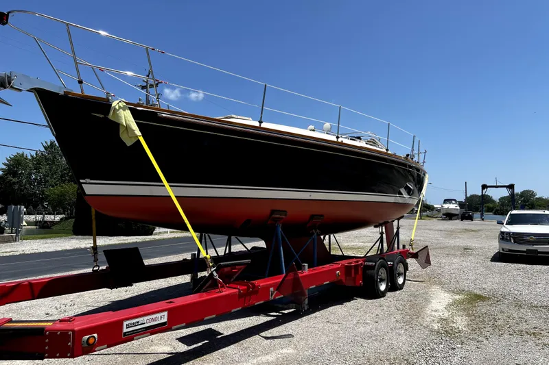 Slide: The Image of 2007 Sabre 386 sailboat on red trailer under clear blue sky. - 15