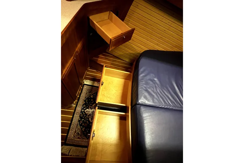 Slide: The Image of Interior of 2007 Sabre 386 yacht with open wooden drawers and blue seating. - 151
