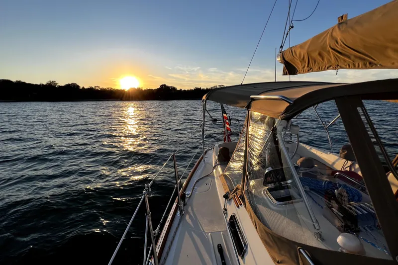 Slide: The Image of Sailboat Sabre 386 (2007) cruising at sunset on a tranquil lake. - 159