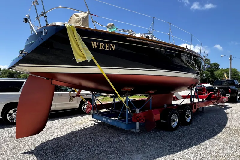 Slide: The Image of 2007 Sabre 386 sailboat "Wren" on trailer, ready for transport under clear blue sky. - 16