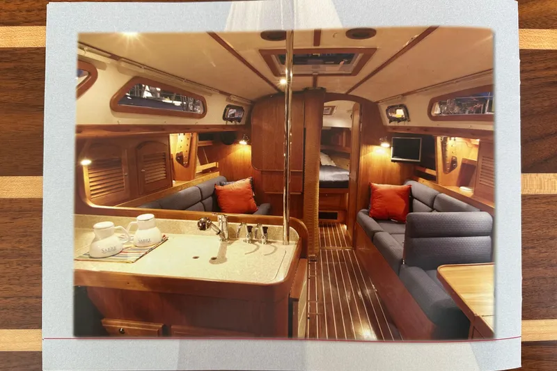 Slide: The Image of Interior of a 2007 Sabre 386 yacht, featuring cozy seating and elegant wood finishes. - 171