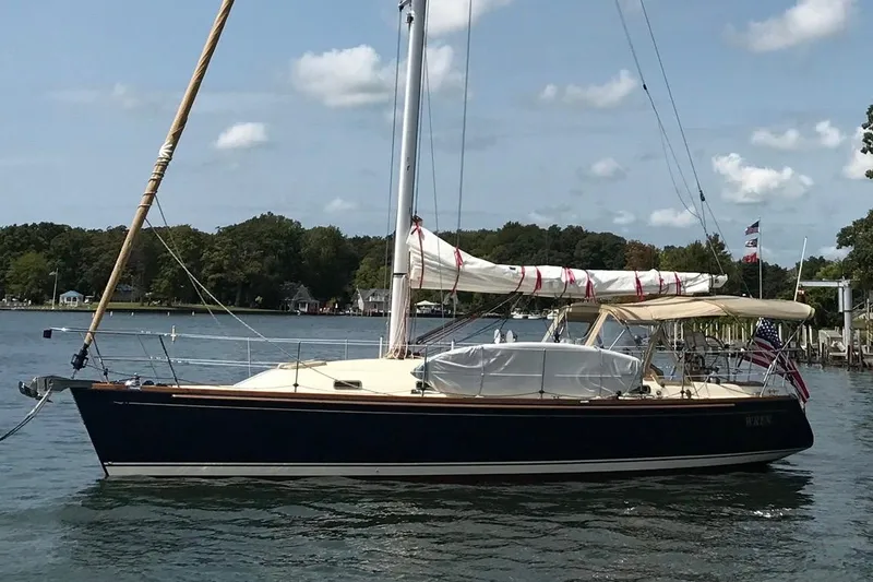 The Image of 2007 Sabre 386 sailboat on calm water with trees in the background. - 0