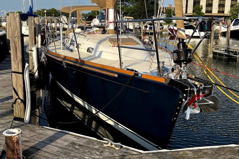 Slide: The Image of 2007 Sabre 386 sailboat docked at marina, featuring sleek design and polished finish. - 2