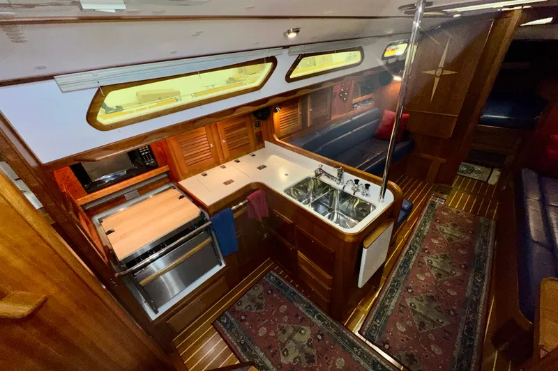 Slide: The Image of Luxurious interior of a 2007 Sabre 386 yacht featuring a well-equipped kitchen and cozy seating area. - 21