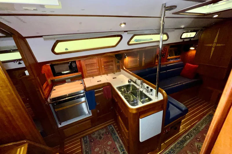 Slide: The Image of Luxurious 2007 Sabre 386 yacht interior with kitchen, seating, and wood finishes. - 22