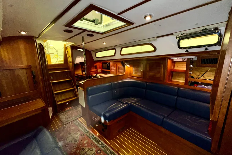 Slide: The Image of Luxurious interior of a 2007 Sabre 386 yacht with wooden finishes and blue seating. - 23