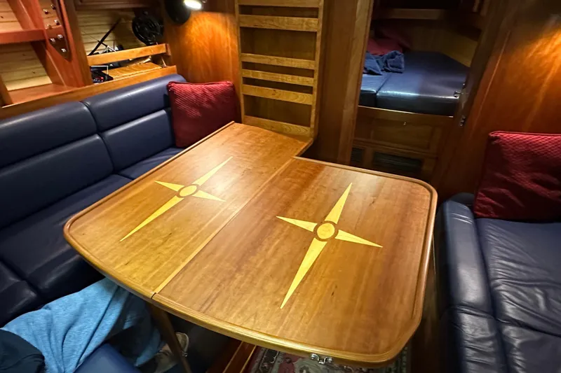 Slide: The Image of Interior of a 2007 Sabre 386 yacht with wooden table and blue seating. - 25