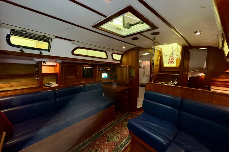 Slide: The Image of Interior of 2007 Sabre 386 yacht with blue seating and wooden finishes. - 26