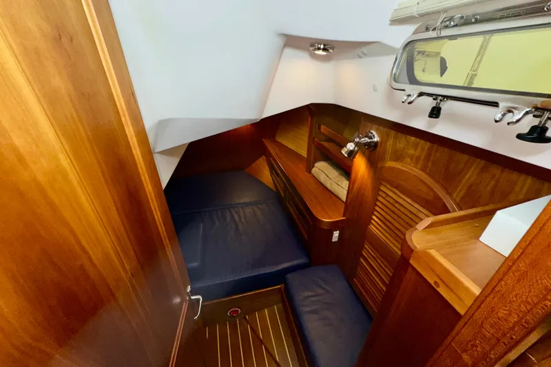 Slide: The Image of Cozy cabin interior of 2007 Sabre 386 yacht with wooden finish and blue cushions. - 28