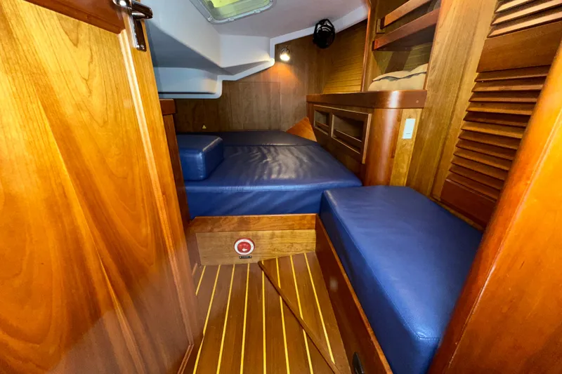 Slide: The Image of Cozy cabin interior of 2007 Sabre 386 yacht with wooden finish and blue cushions. - 29