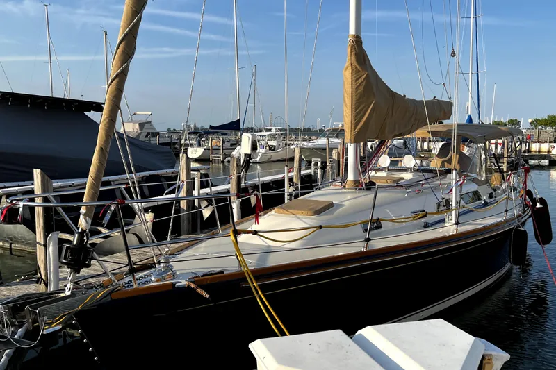 Slide: The Image of 2007 Sabre 386 sailboat docked at a marina under clear blue skies. - 3