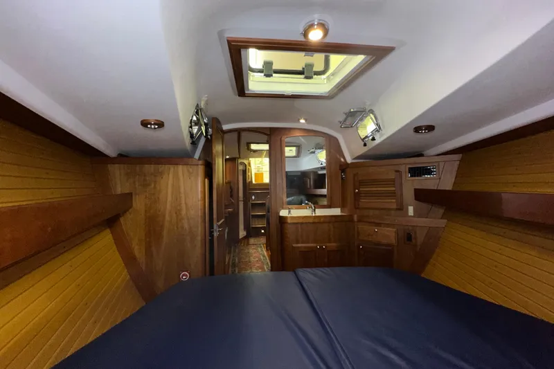 Slide: The Image of Interior of a 2007 Sabre 386 yacht, featuring wood paneling and a skylight. - 37