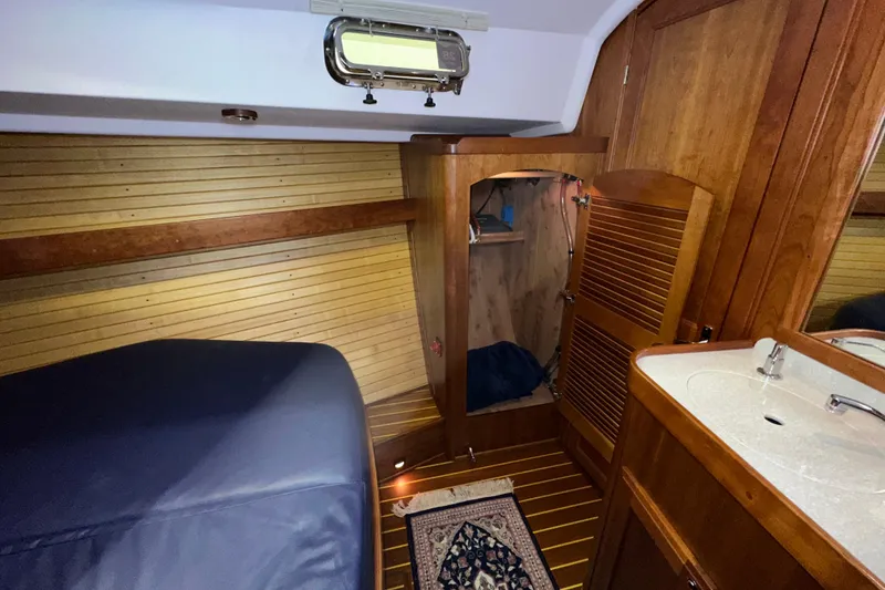 Slide: The Image of Luxurious 2007 Sabre 386 yacht cabin with wooden interior and cozy sleeping area. - 38