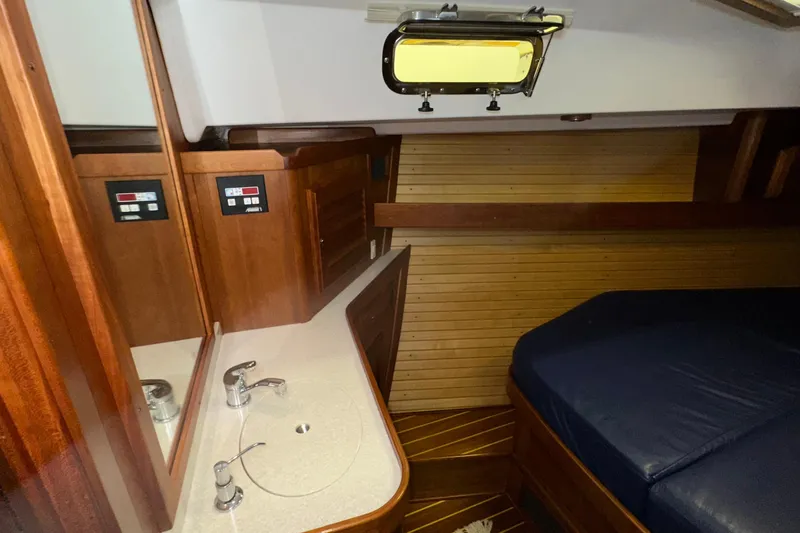 Slide: The Image of Luxurious 2007 Sabre 386 yacht interior with wooden cabinetry and cozy sleeping area. - 39