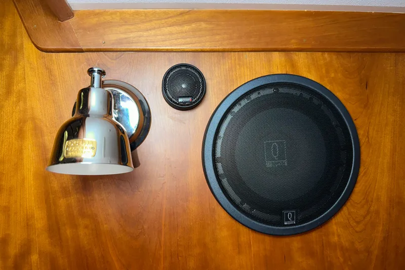 Slide: The Image of Wall-mounted chrome light and speakers on a wooden panel in a 2007 Sabre 386. - 46