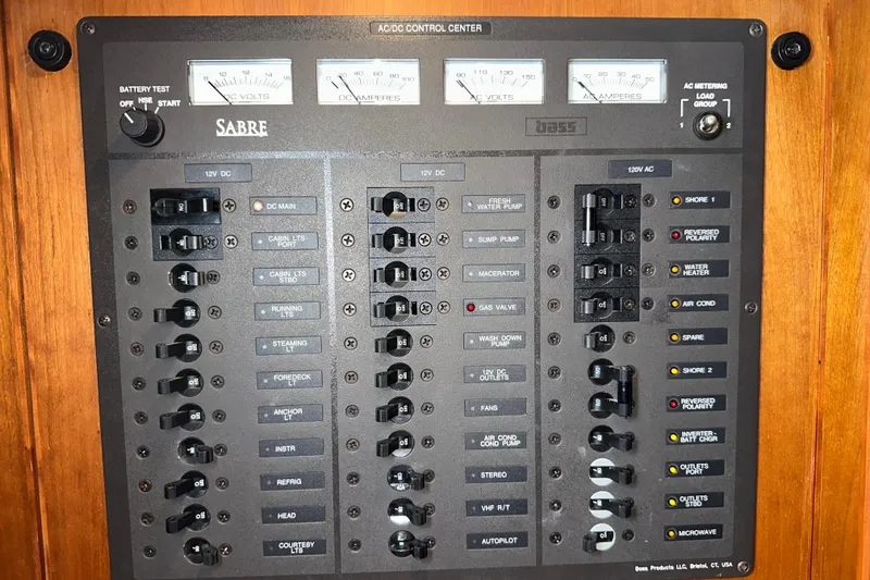 Slide: The Image of Electrical control panel of a 2007 Sabre 386 boat with various switches and meters. - 50