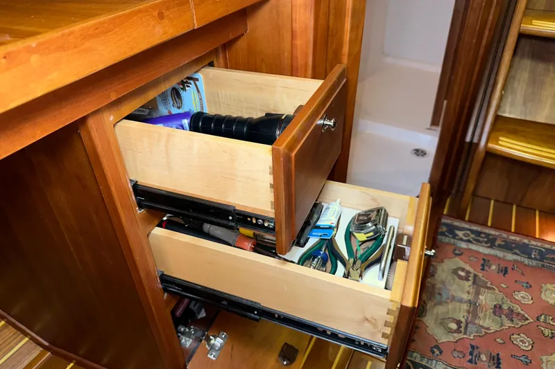 Slide: The Image of Wooden drawers in a 2007 Sabre 386 yacht, containing tools and accessories. - 53