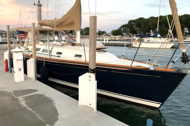 Slide: The Image of Sailboat docked at marina, Sabre 386, 2007 model, with American flag and calm waters. - 6