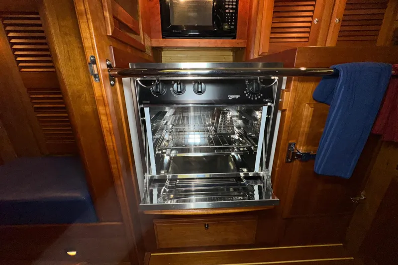 Slide: The Image of Open oven in a wooden kitchen interior on a 2007 Sabre 386 yacht. - 60