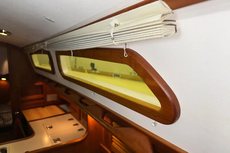 Slide: The Image of Interior of 2007 Sabre 386 yacht, featuring wooden trim and window blinds. - 62