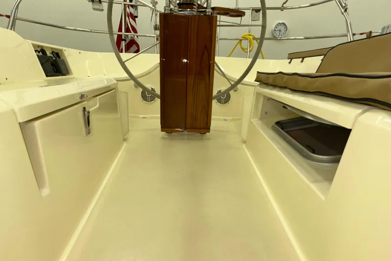 Slide: The Image of 2007 Sabre 386 yacht cockpit with steering wheel, storage compartments, and beige seating. - 71
