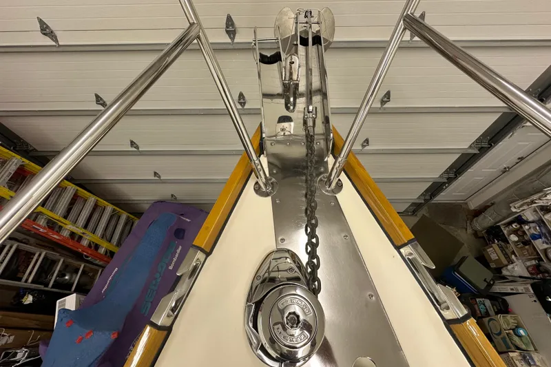 Slide: The Image of Bow of 2007 Sabre 386 sailboat with anchor chain and winch in a garage. - 74
