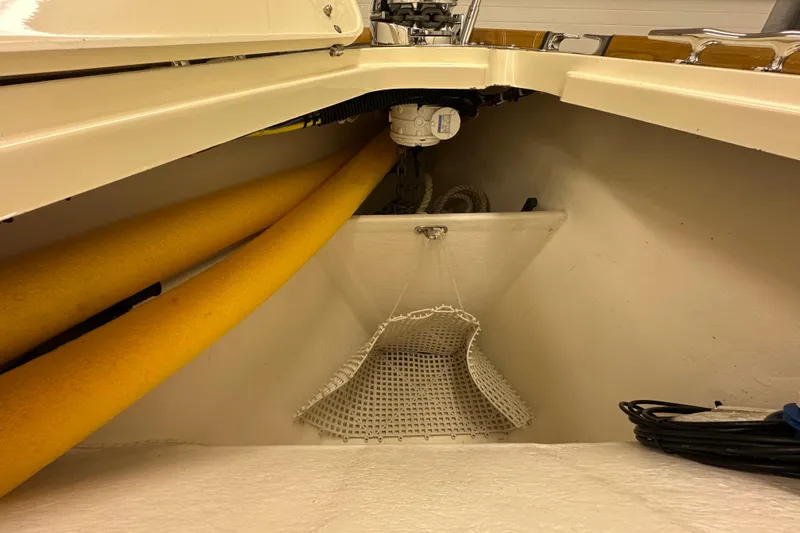Slide: The Image of Interior view of a 2007 Sabre 386 sailboat showing storage area with yellow pipes. - 76