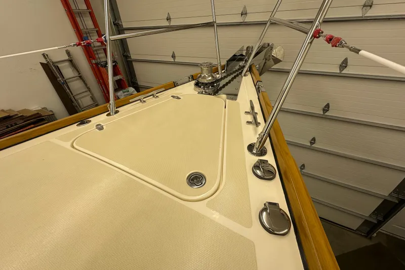 Slide: The Image of 2007 Sabre 386 yacht deck with stainless steel fittings and winch in a garage setting. - 77